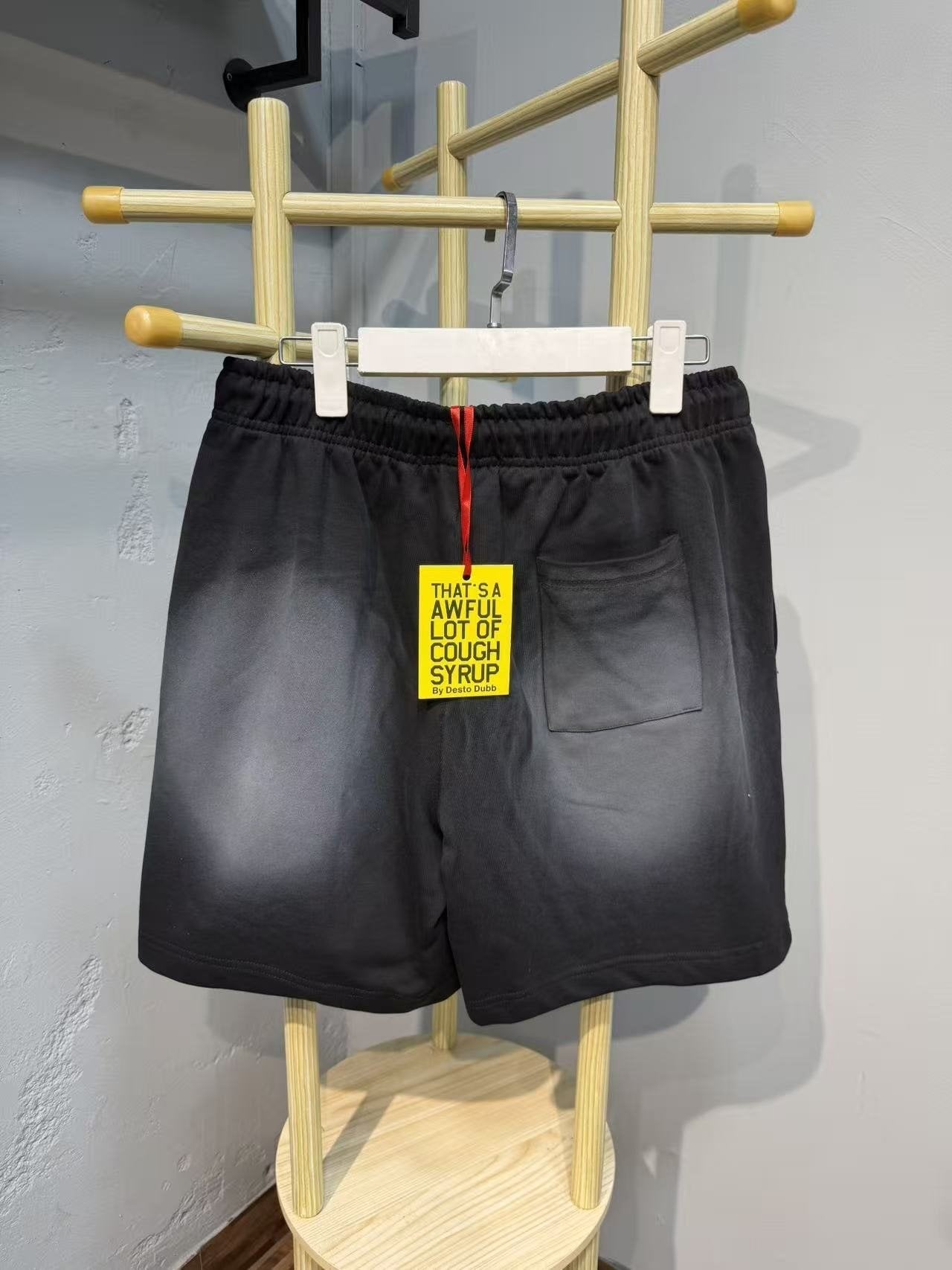 THAT'S A AWFUL LOT OF COUGH SYRUP Black Graphic Drawstring Shorts — back